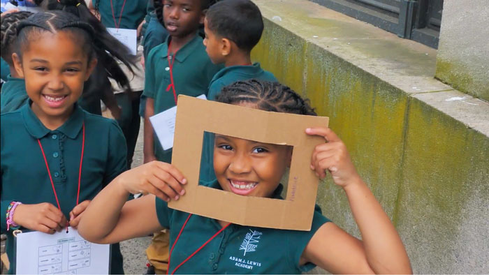 Video Thumbnail for the Based in Play documentary featuring two girls engaging in a play-based learning project outdoors