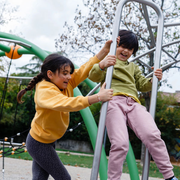 two girls on a jungle gym
