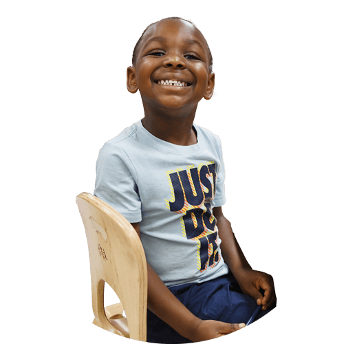 A young male student at his desk smiling
