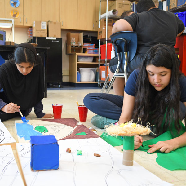 Middle SchoolGirls working on an art-project on the floor