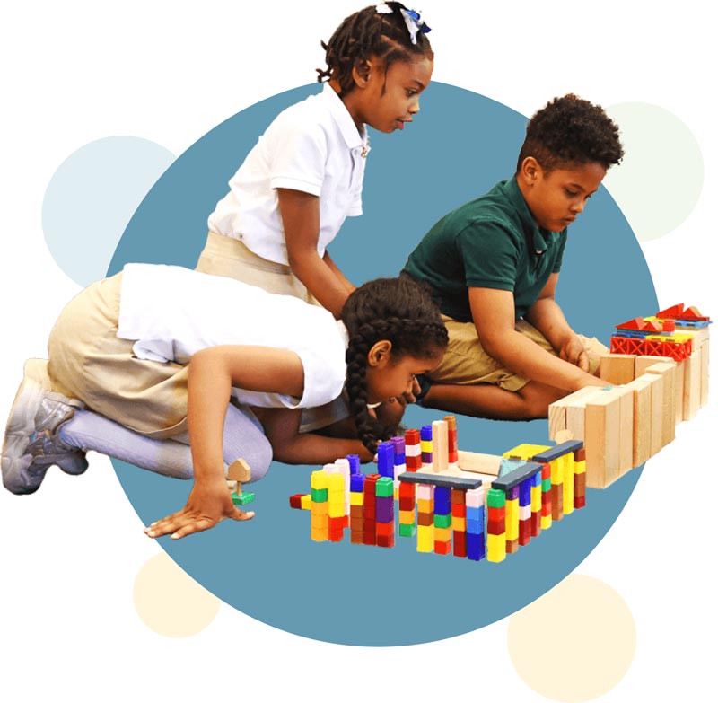 Two girls and a boy playing with blocks