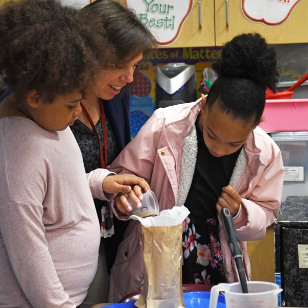 Teacher overseeing a science project